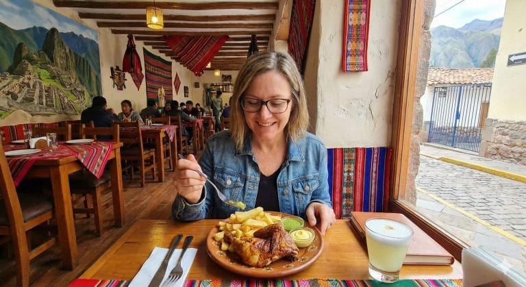 A woman eating pollo a la brasa at a restaurant in Peru
